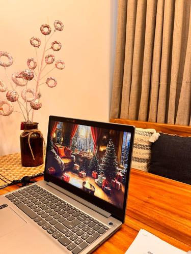a laptop computer sitting on top of a desk at SMDC Green 2 Staycation, The Traditional & Modern Fusion Condo in Pasong Bayog
