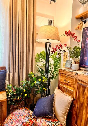 a living room with a lamp and some plants at SMDC Green 2 Staycation, The Traditional & Modern Fusion Condo in Pasong Bayog