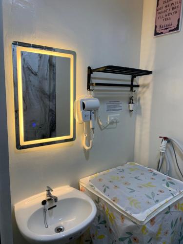a hospital room with a sink and a bed at PARANAQUE STAYCATION at SPRING RESIDENCES T3 U1231 in Manila