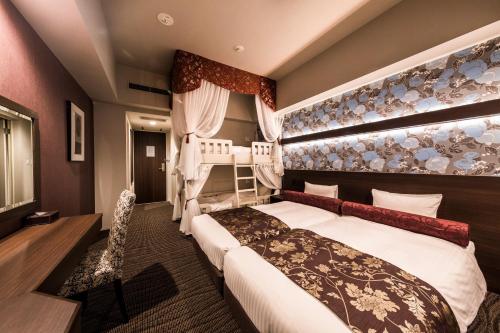 Postel nebo postele na pokoji v ubytování Hotel WBF Sapporo Chuo