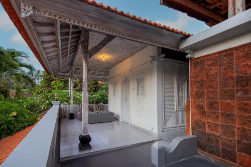 an outdoor patio of a house with a roof at Ganesh Beach Hotel in Candidasa
