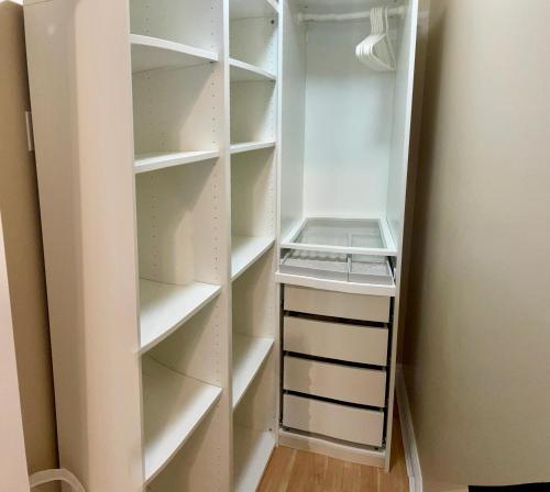 a walk in closet with white shelves at Rose Garden Vancouver in Richmond
