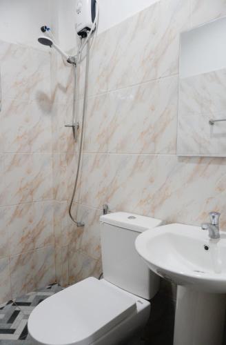 a bathroom with a shower and a toilet and a sink at Blue House El Nido in El Nido