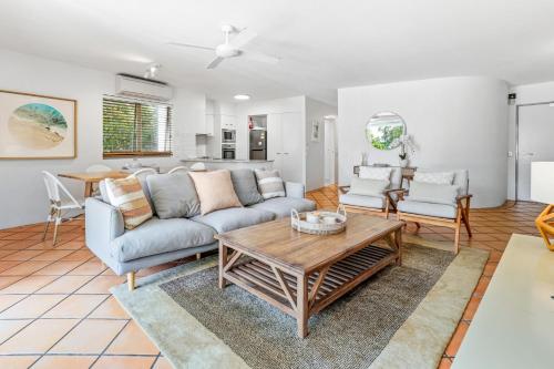 a living room with a couch and a table at The Cove Noosa - Apartment 6 in Noosa Heads