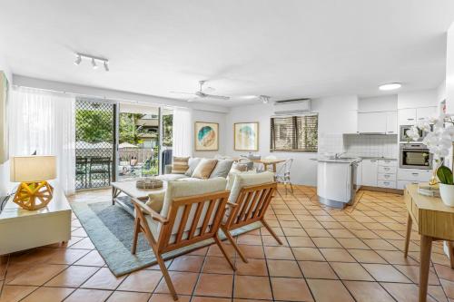 a living room with a couch and a table at The Cove Noosa - Apartment 6 in Noosa Heads