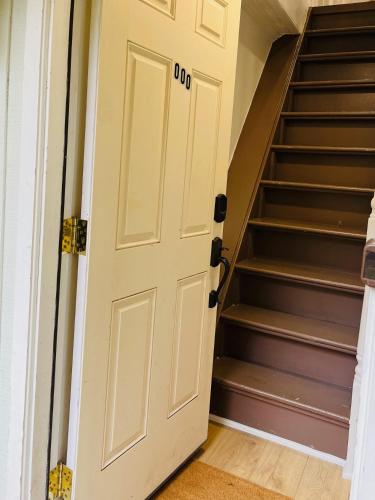 a door leading up to a staircase in a house at Paloma, Large Attic Apartment in Shandaken