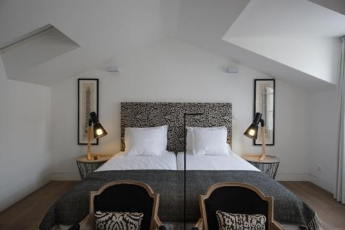 מיטה או מיטות בחדר ב-Alma Moura Residences