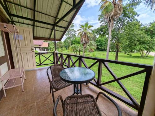 a patio with a table and chairs on a balcony at RS Phong Riverside Resort in Khon Kaen