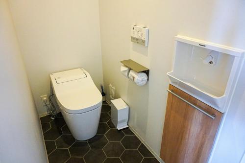 a small bathroom with a toilet and a sink at Hotel Imagine Kyoto in Kyoto