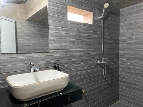 a bathroom with a white sink and a shower at Cao bành Homestay in Ha Giang