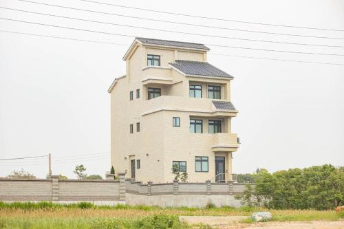 a tall building with a fence in front of it at 98Guesthouse in Jincheng
