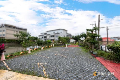 a cobblestone road with trees and buildings in a city at ChaoPingJia Homestay in Luodong