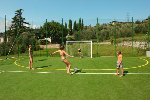 a group of people standing on a soccer field at Park Hotel Val Di Monte ***S in Malcesine