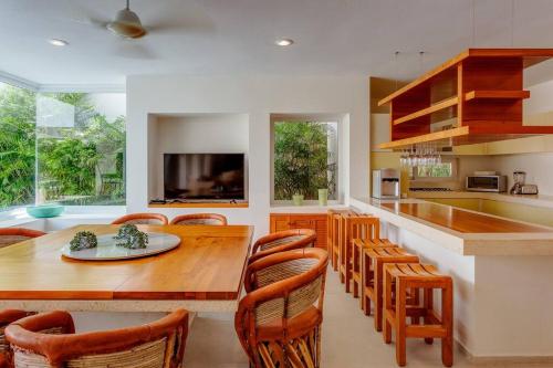 a kitchen with a large wooden table and chairs at Dream House with private Deck in Puerto Aventuras in Puerto Aventuras