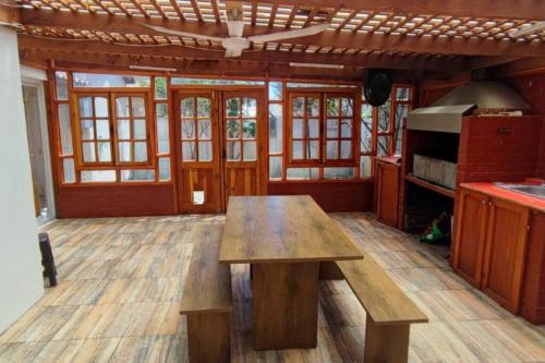 a kitchen with a wooden table in a room at Casa acogedora puertas del Mar in La Serena