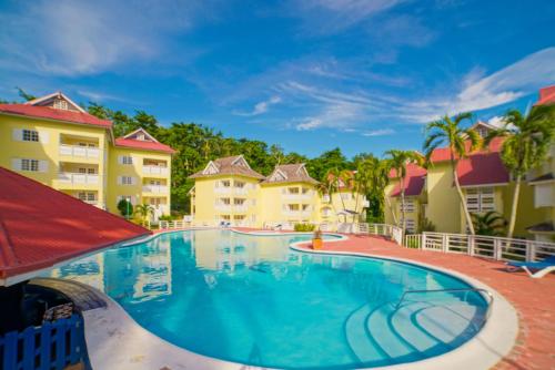 a swimming pool at a resort with condos at Mystical Studios King in Ocho Rios