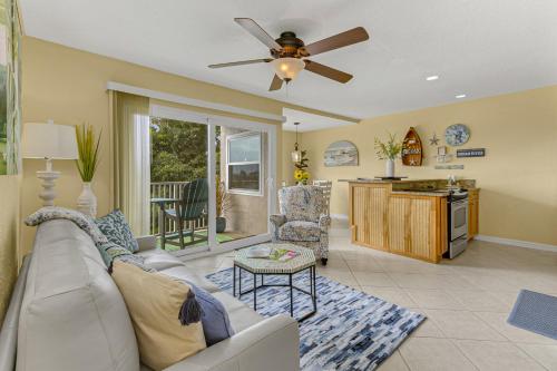 a living room with a couch and a ceiling fan at Haven Harbor Getaway in Melbourne