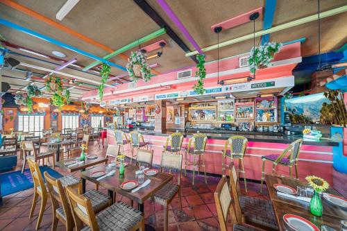 a restaurant with tables and chairs and a bar at Rock Apartments by Lowkl in Miami Beach