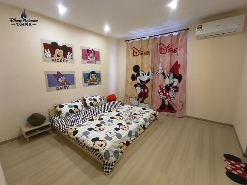 a bedroom with a bed with mickey mouse bedding at Disney Playhouse Tampin AFamosa Melaka Alor Gajah in Tampin