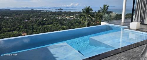a swimming pool on top of a house at Balcony on the sea in Amphoe Koh Samui