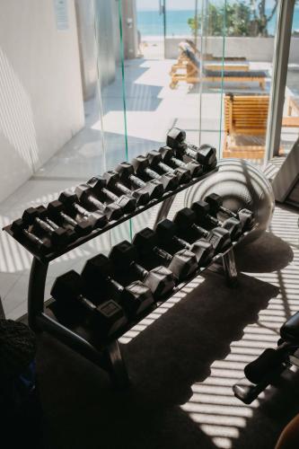 a close up of a group of dumbbells in a room at On The Beach Noosa Resort in Noosa Heads