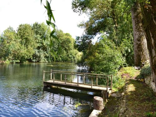 a bench sitting on a bridge over a river at Gîte familial avec jardin au bord de l'eau, terrasses, vélo, jeux, proche Charente, WiFi inclus - FR-1-653-189 in Saint-Genis-dʼHiersac
