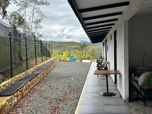 a porch with benches on the side of a house at Finca el mirador el Carmen in Borrero Ayerbe