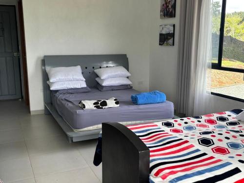 a bedroom with a bed with a cow blanket on it at Finca el mirador el Carmen in Borrero Ayerbe