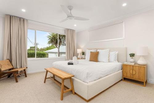 ein weißes Schlafzimmer mit einem großen Bett und einem Fenster in der Unterkunft Tide's Edge by Experience Jervis Bay in Vincentia