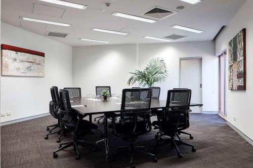 a conference room with a table and chairs at Quality Hotel Dickson in Canberra