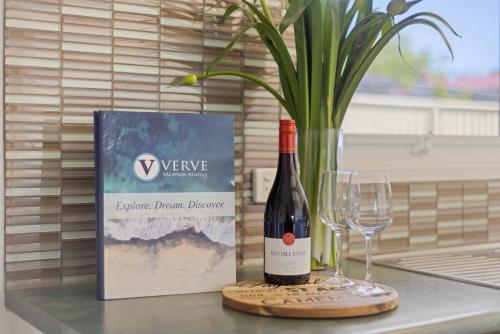 a bottle of wine and two glasses on a counter at Rose by the Bay in Tootgarook