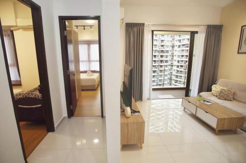 a living room with a couch and a living room with a window at Cozy Beach Escape: 2BR Muji Gem in Johor Bahru