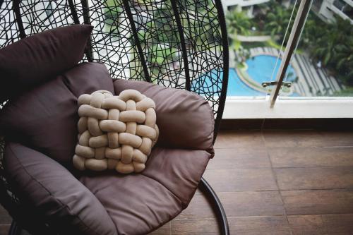 a brown chair with a paw carved on it at Cozy Beach Escape: 2BR Muji Gem in Johor Bahru