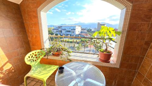 a bathroom with a window with a table and a yellow chair at ChaoPingJia Homestay in Luodong