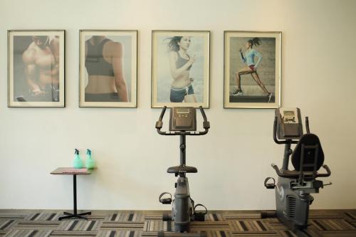 a room with pictures on the wall and a camera at Cozy Beach Escape: 2BR Muji Gem in Johor Bahru
