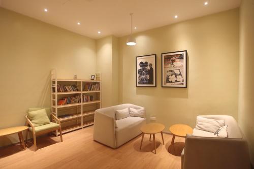 a living room with a couch and chairs and a table at Cozy Beach Escape: 2BR Muji Gem in Johor Bahru