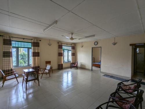 a large room with chairs and a table and windows at Seven Star Guest Inn in Passara