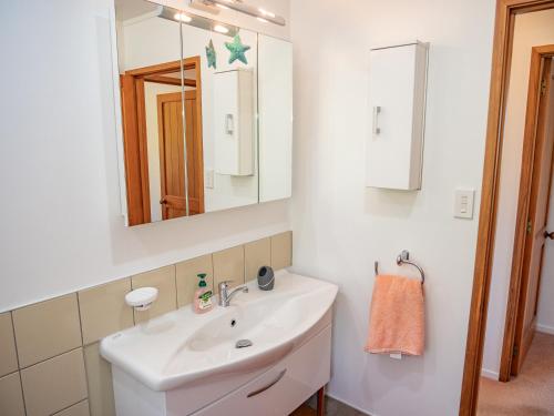 a bathroom with a sink and a mirror at Serenity Hills - Mangonui Holiday Home in Mangonui