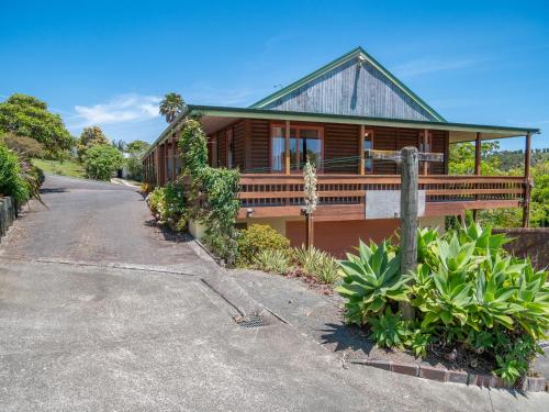 a wooden house with a road leading to it at Serenity Hills - Mangonui Holiday Home in Mangonui