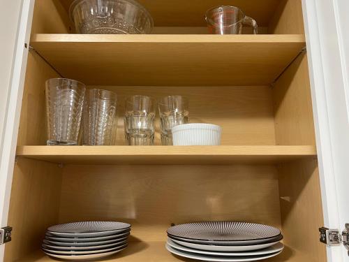 two stacks of plates and glasses on a shelf at Mad Men in Salem