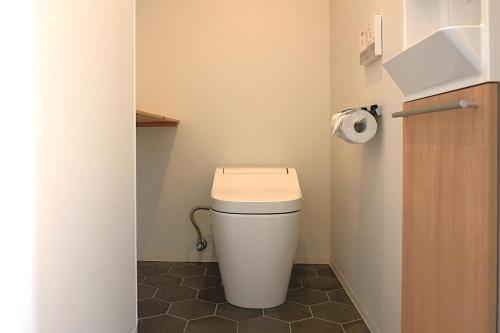 a bathroom with a toilet with a roll of toilet paper at Hotel Imagine Kyoto in Kyoto