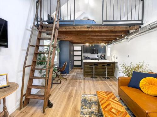 a loft apartment with a ladder and a living room at Unique Denver Tiny House Skiing, Shopping, Hiking in Englewood