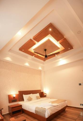 a bedroom with a large bed with a ceiling at Silver cascade in Devikolam