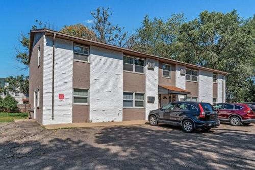 a building with cars parked in front of it at Tranquil 2BR Apt Mpls - 8075 Apt 4 in Spring Lake Park
