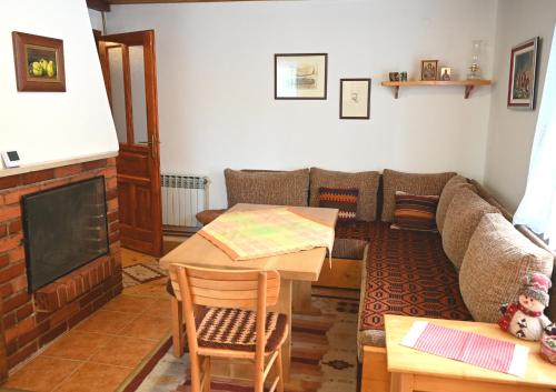 a living room with a couch and a table at Vikendica Mašan in Pale