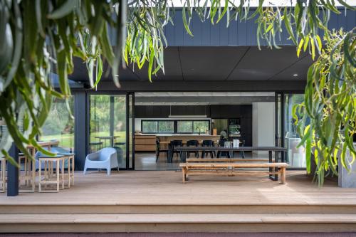a building with a patio with benches and tables at The Tempest I Private Properties in Quindalup