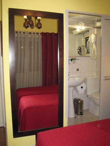 a bathroom with a red shower curtain and a sink at Faria Guimares Porto Centro in Porto