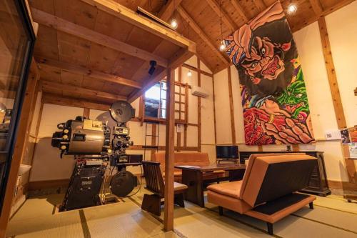 a room with a recording studio with a camera and a desk at 青森蔵泊 in Kuroishi