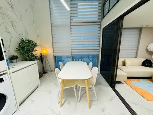 a white table and chairs in a living room at Majestic Seoul Stay Central in Seoul