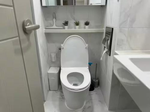 a small bathroom with a toilet and a sink at Majestic Seoul Stay Central in Seoul